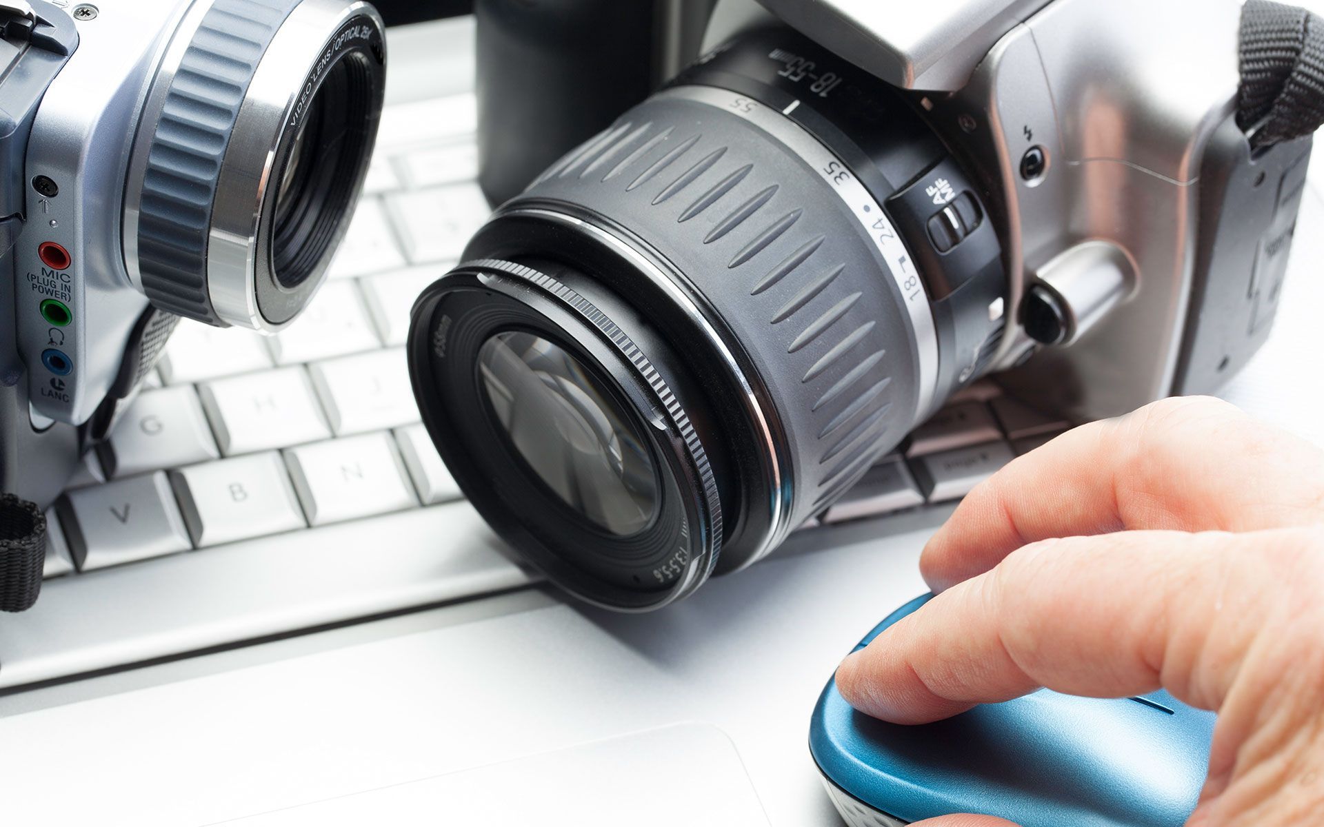 A person is using a computer mouse next to a camera