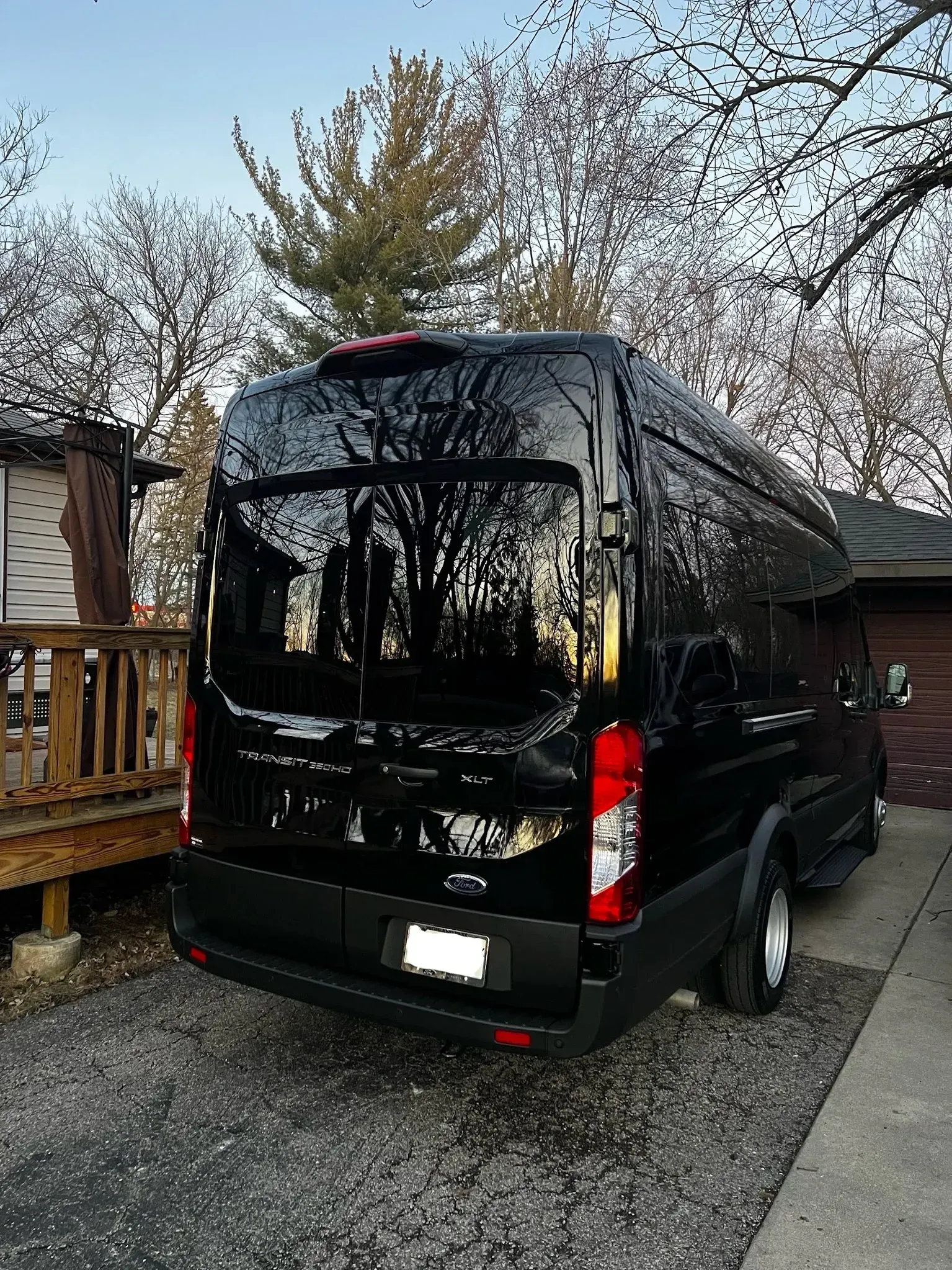 A black van is parked in front of a house.