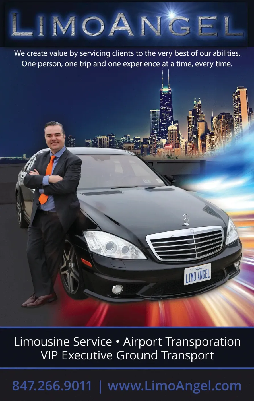 A man in a suit is standing next to a black mercedes