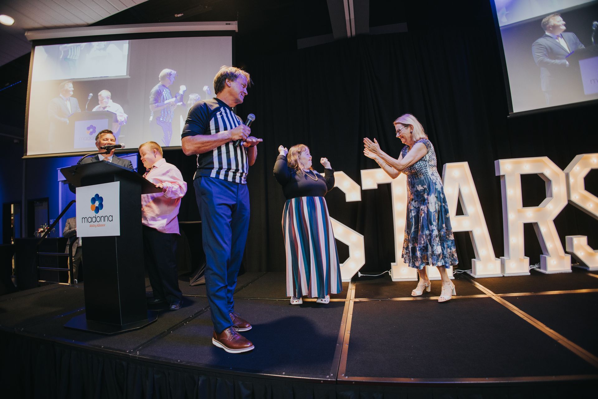 People on stage at an awards event with