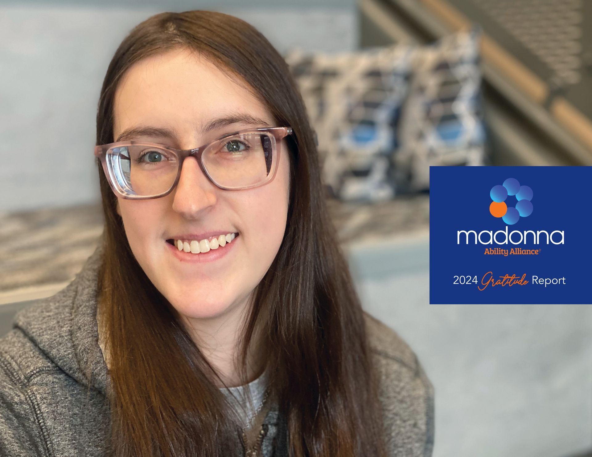 Woman with glasses smiles; Madonna logo, 
