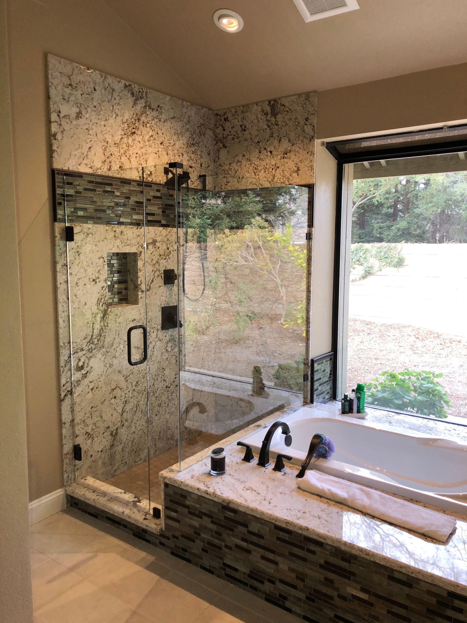 A bathroom with a bathtub , sinks , mirror and wooden walls.