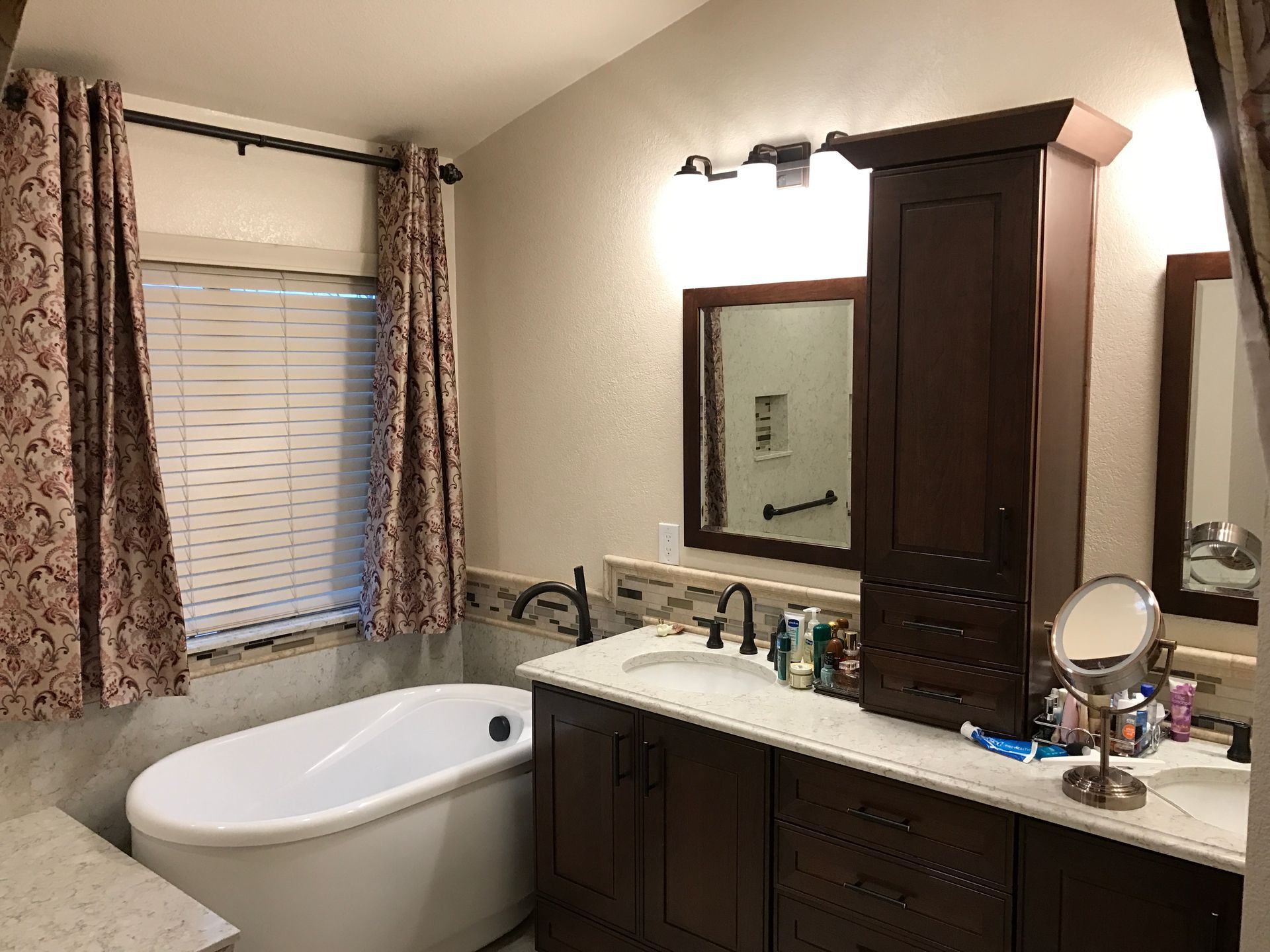 A bathtub with a faucet and a pillow on it in a bathroom.