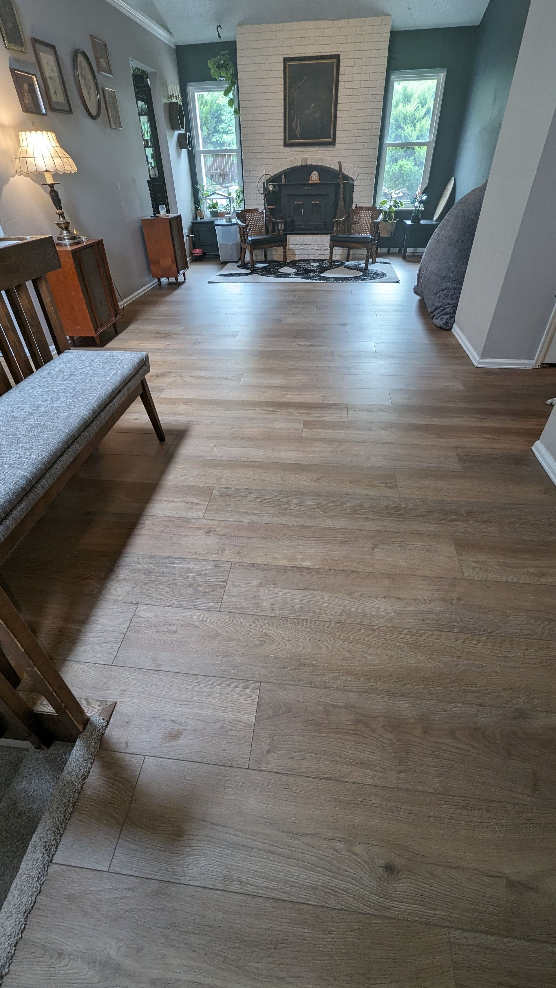 A living room with hardwood floors and a fireplace.