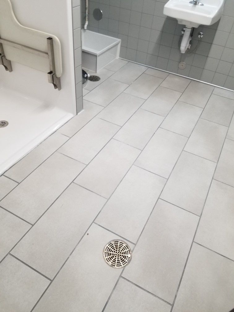 A bathroom with tile floors and a sink