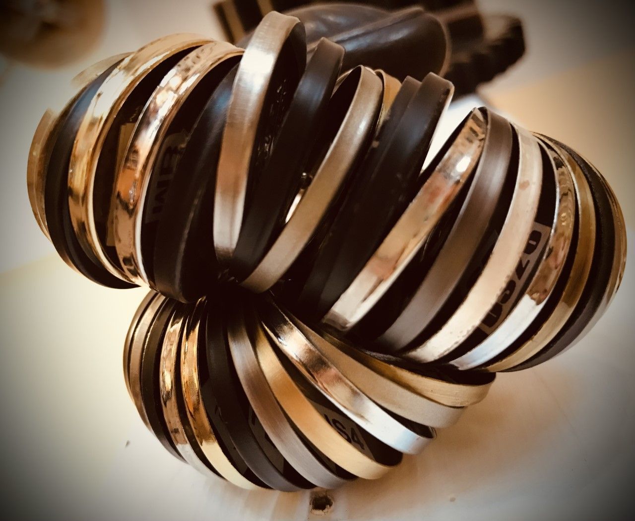 Stacked black and silver bangle bracelets.