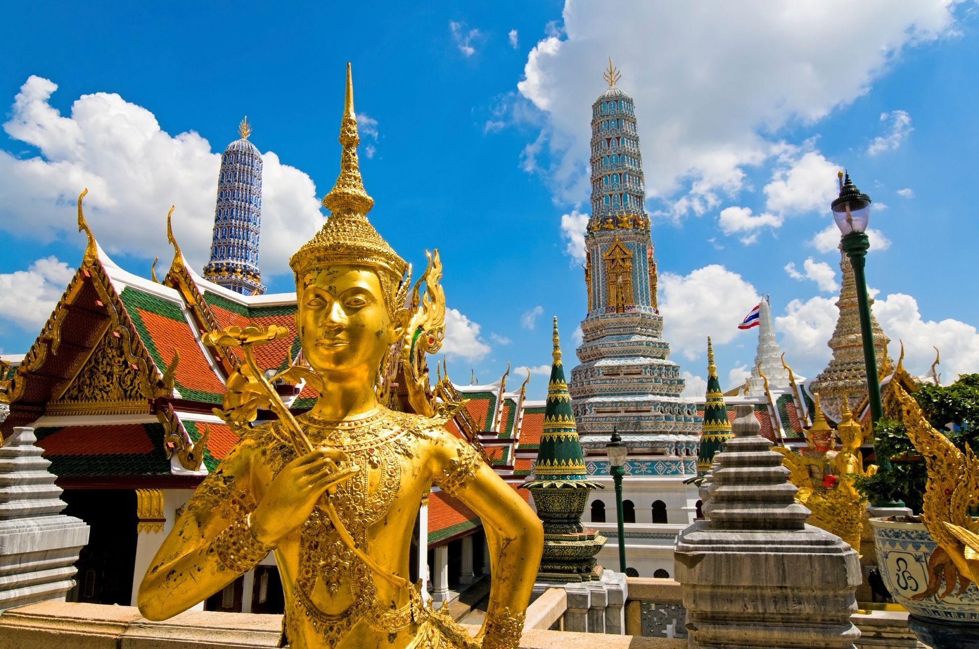 Thailand here is a statue of a woman in front of a temple.