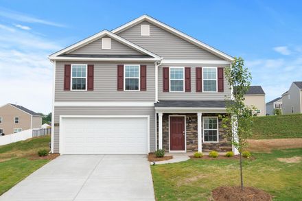 A two-story suburban house with grey siding, a white garage door, a dark red front door, and a stone facade entry.