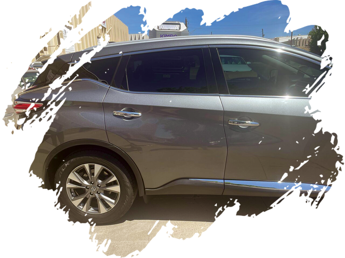 A gray suv is parked in front of a building