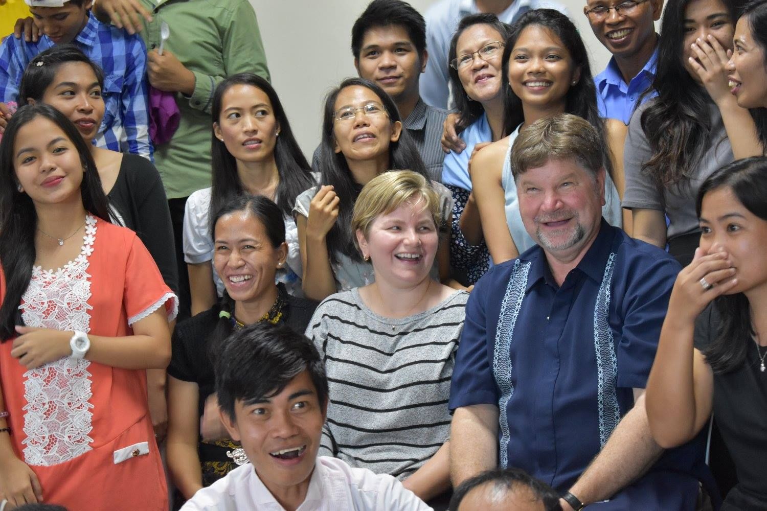 A group of people are posing for a picture together and smiling.