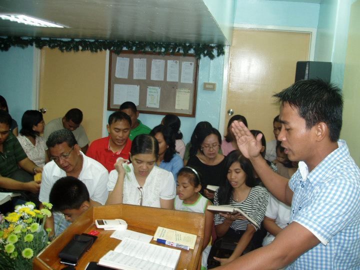 A man is giving a speech to a group of people