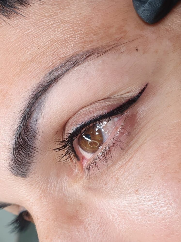 Eye with freshly applied permanent eyeliner tattoo and groomed brows — Artisan Cosmetic Tattoo, Worongary QLD