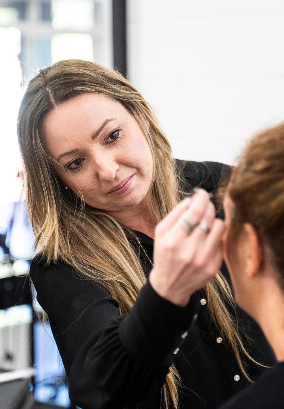 Woman Applying Makeup on Another Person's Face; Indoors — Artisan Cosmetic Tattoo & Beauty in Worongary, QLD