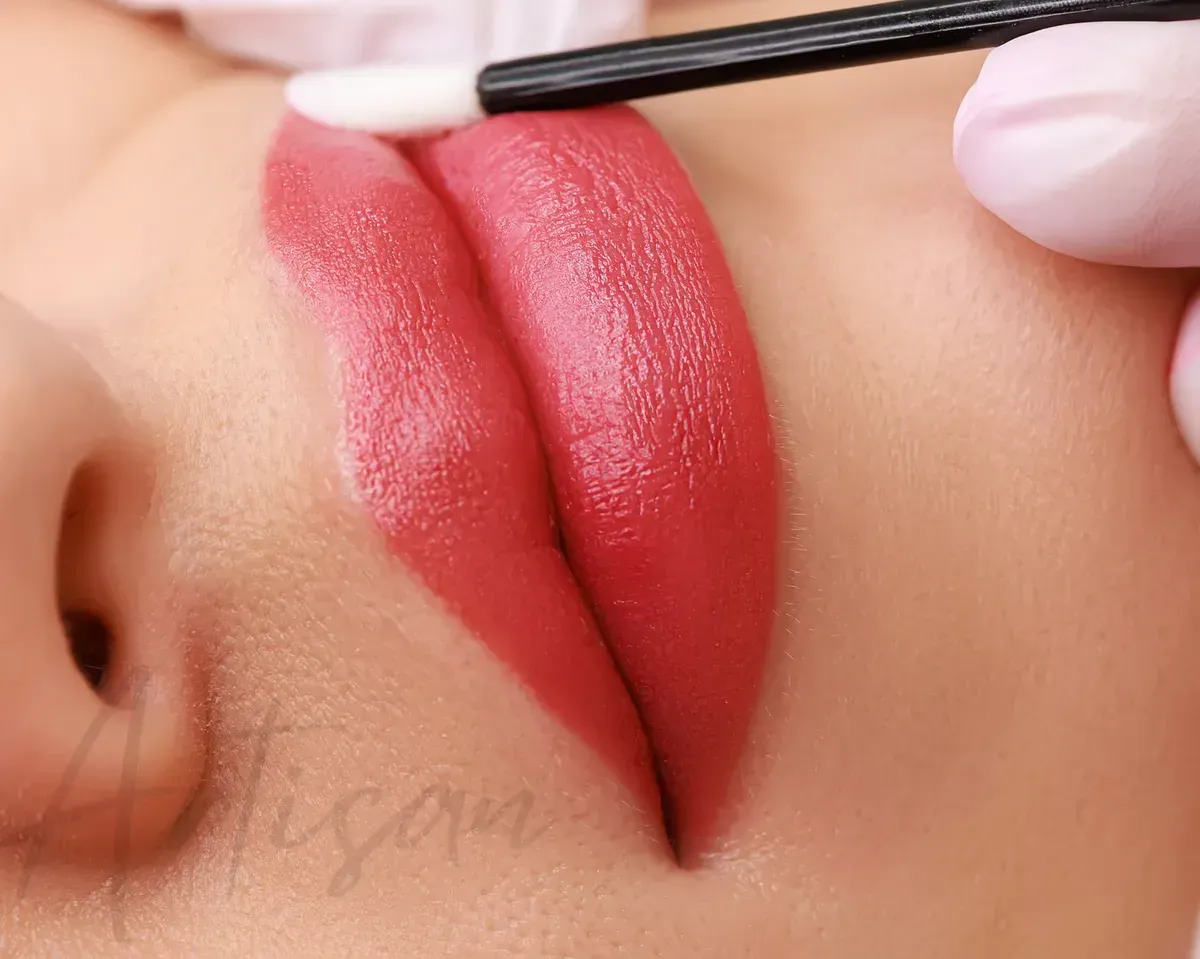 Lip blush tattoo being applied to a client's lips — Artisan Cosmetic Tattoo & Beauty in Worongary, QLD