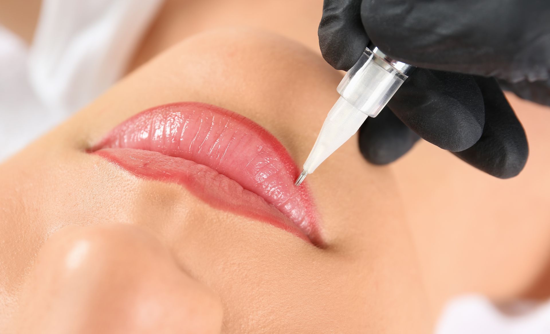 Black-gloved hand using a microblading tool — Artisan Cosmetic Tattoo & Beauty in Worongary, QLD