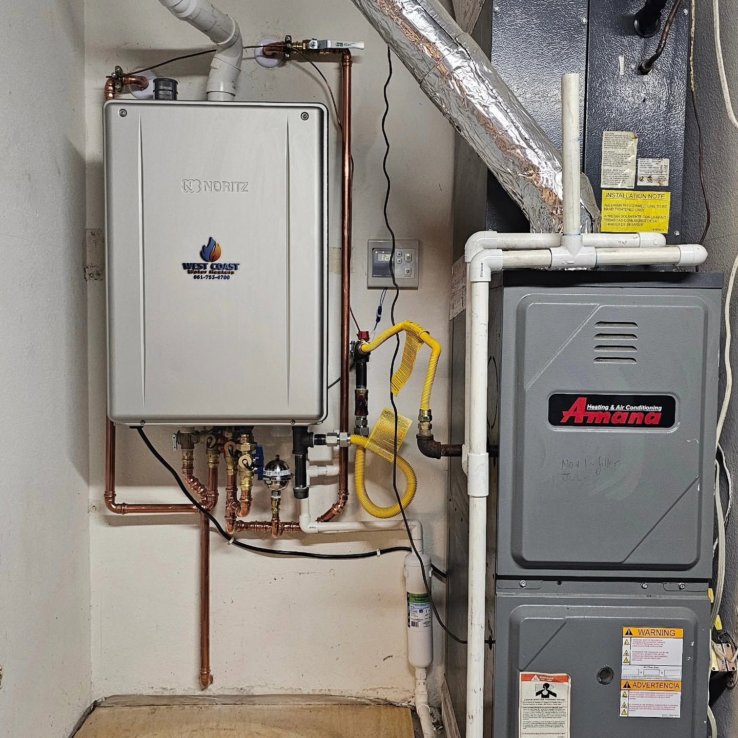 Residential utility closet with furnace, water heater, and exposed pipes and ductwork.