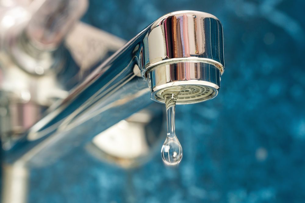 A Close Up Of A Water Faucet With A Drop Of Water Coming Out Of It - San Diego, CA - S.O.S. Affordable Rooter Plumbing A Close Up Of A Water Faucet With A Drop Of Water Coming Out Of It - San Diego, CA - S.O.S. Affordable Rooter Plumbing