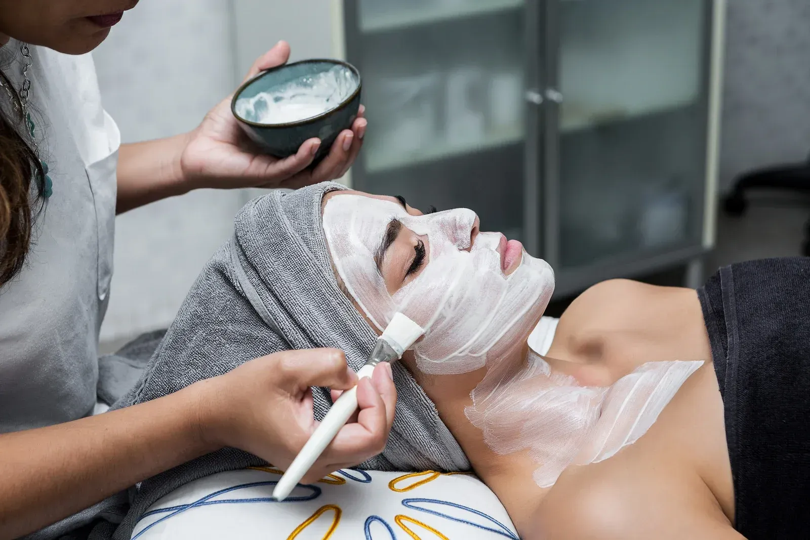 A woman is getting a facial treatment at a spa.