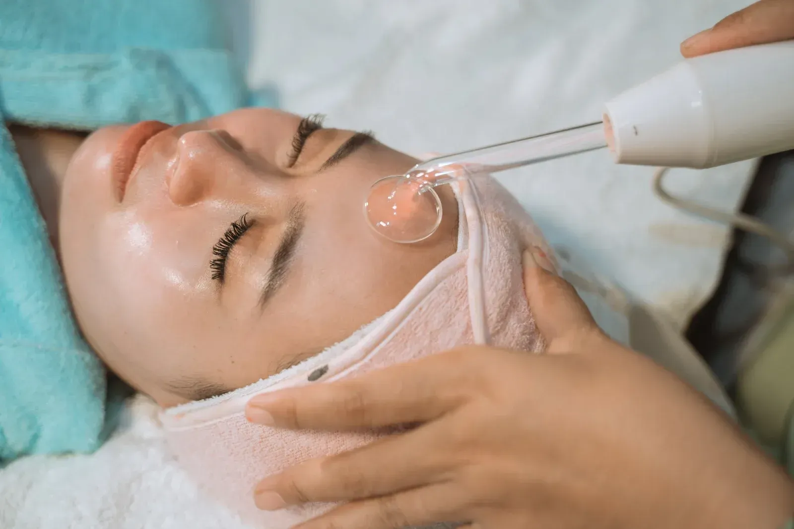 A woman is getting a facial treatment at a spa.