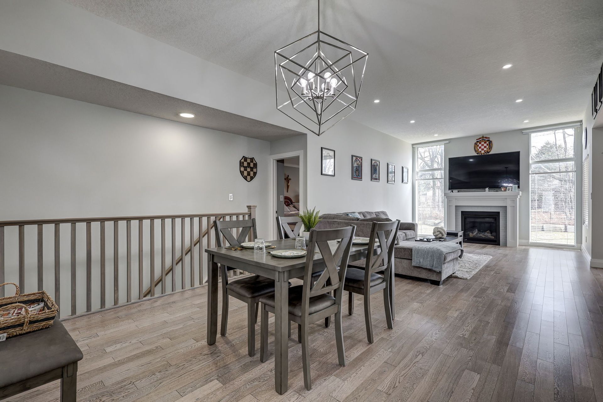 Dining and living room with geometric pendant light and fireplace