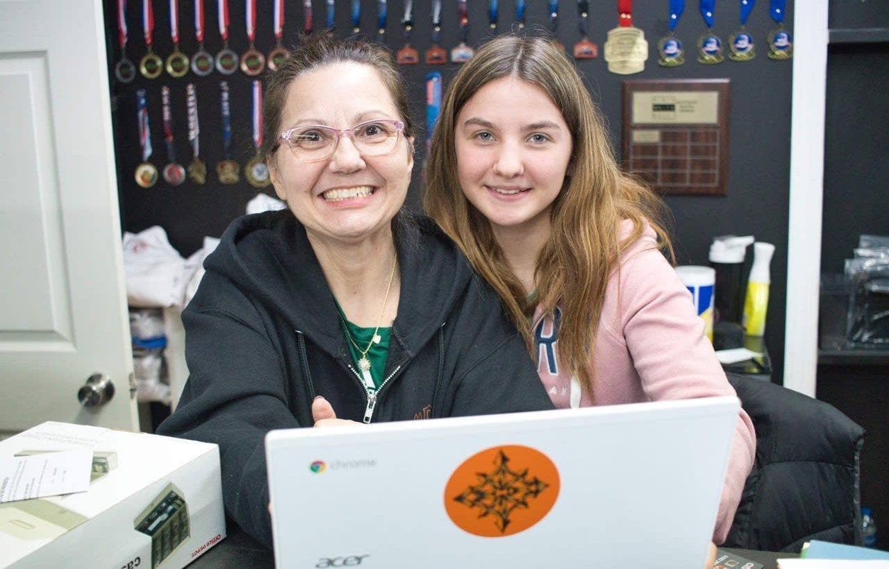 Woman and girl smiling.