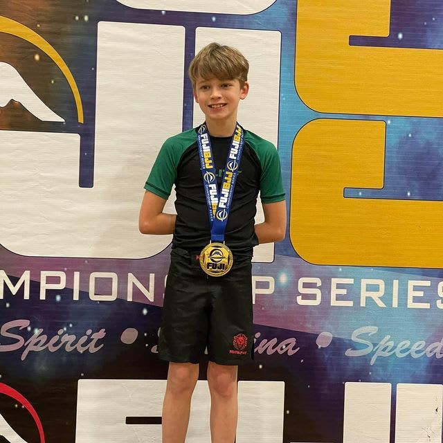 Boy in black and green gi.