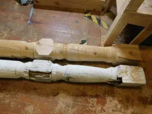 two wooden poles are sitting on a wooden floor next to each other .