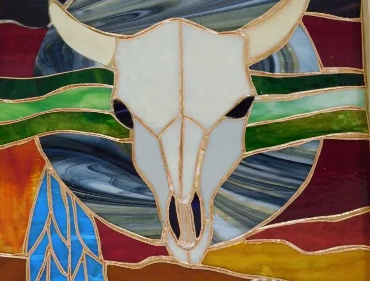 a stained glass painting of a bull skull