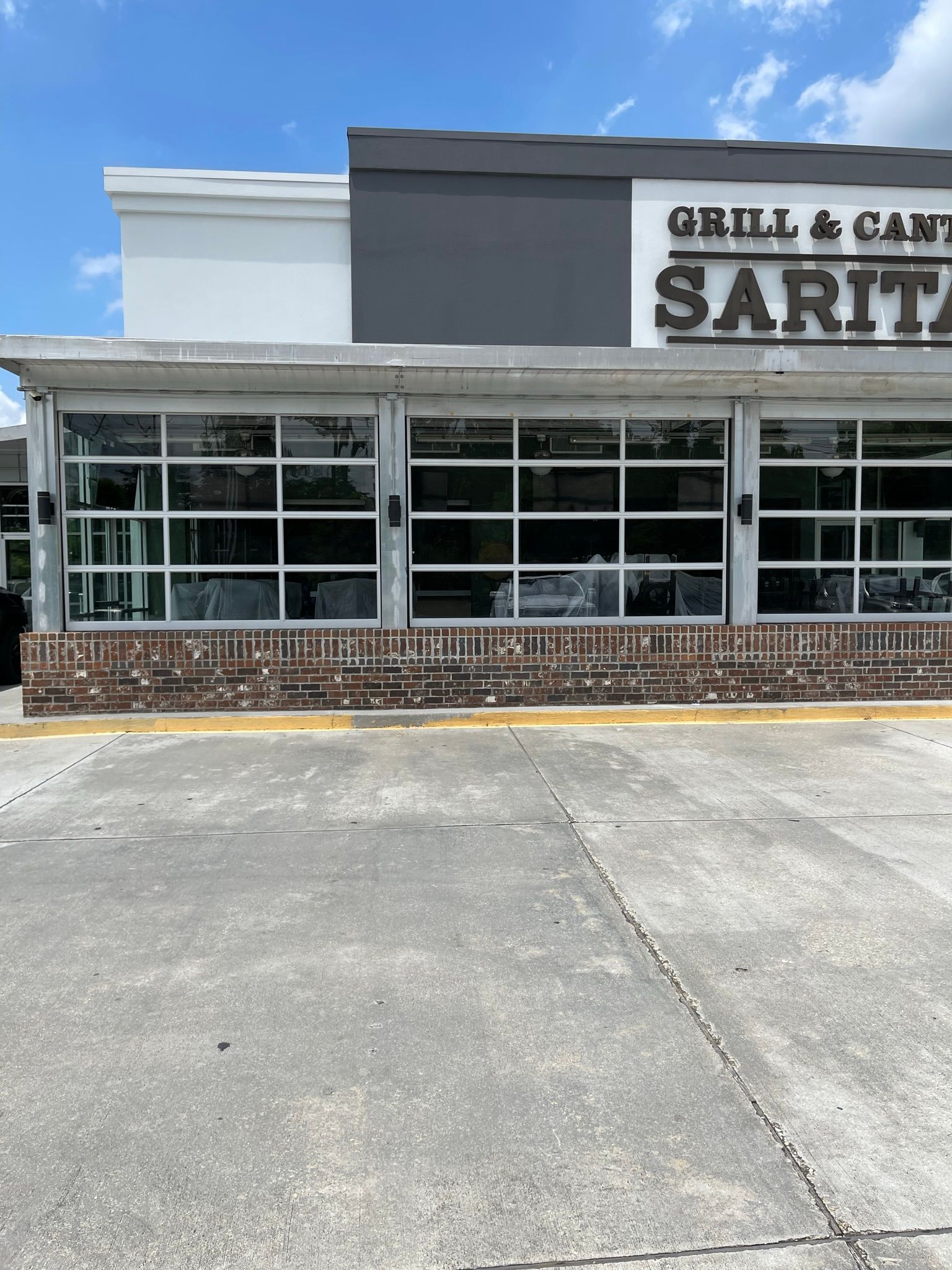 Restaurant facade with large glass windows; 
