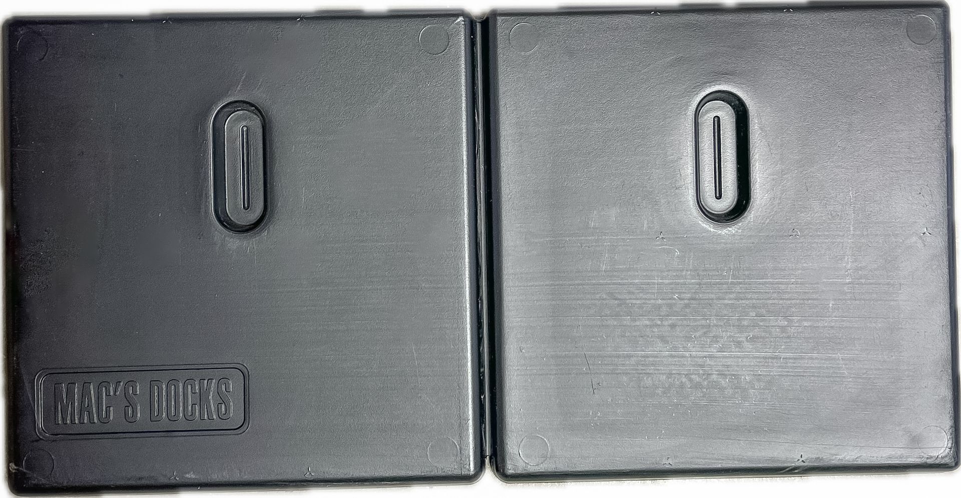 Two gray rectangular buttons with small vertical slots on top, side by side on a white background