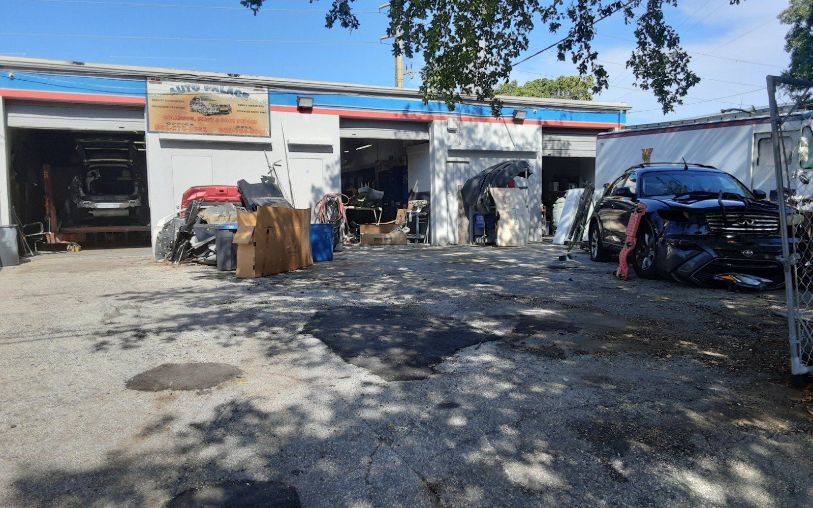 A garage with a lot of cars parked in front of it