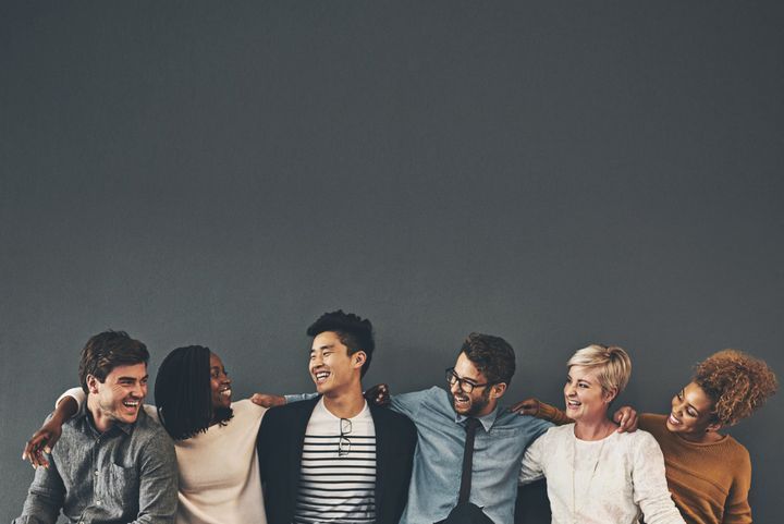 Multi race people  holding each other and smiling