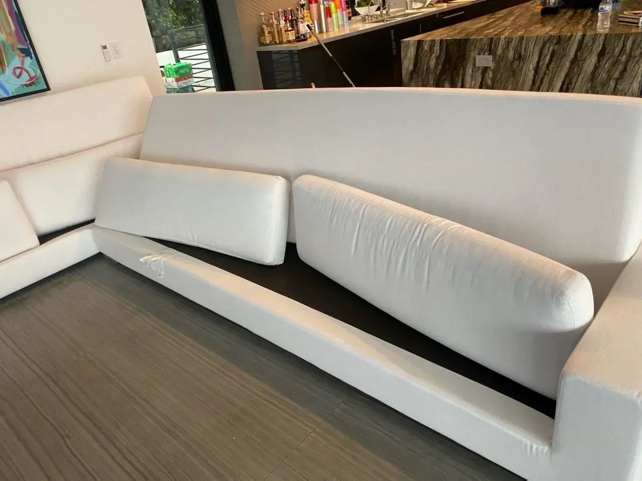 Modern white sectional sofa with matching cushions in a minimalist interior
