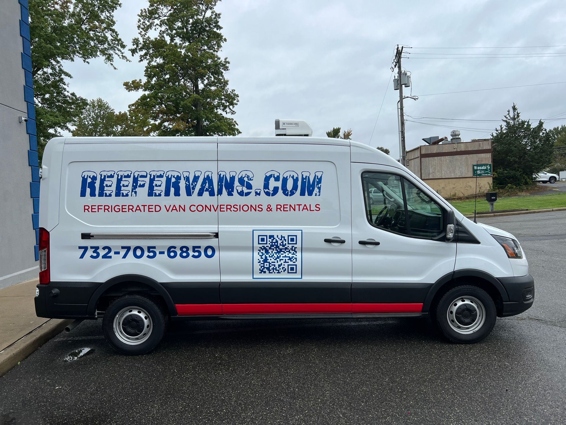 A side view of a white commercial van with 