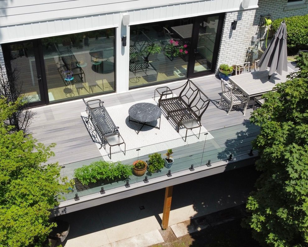 An aerial view of a deck with furniture and umbrellas.