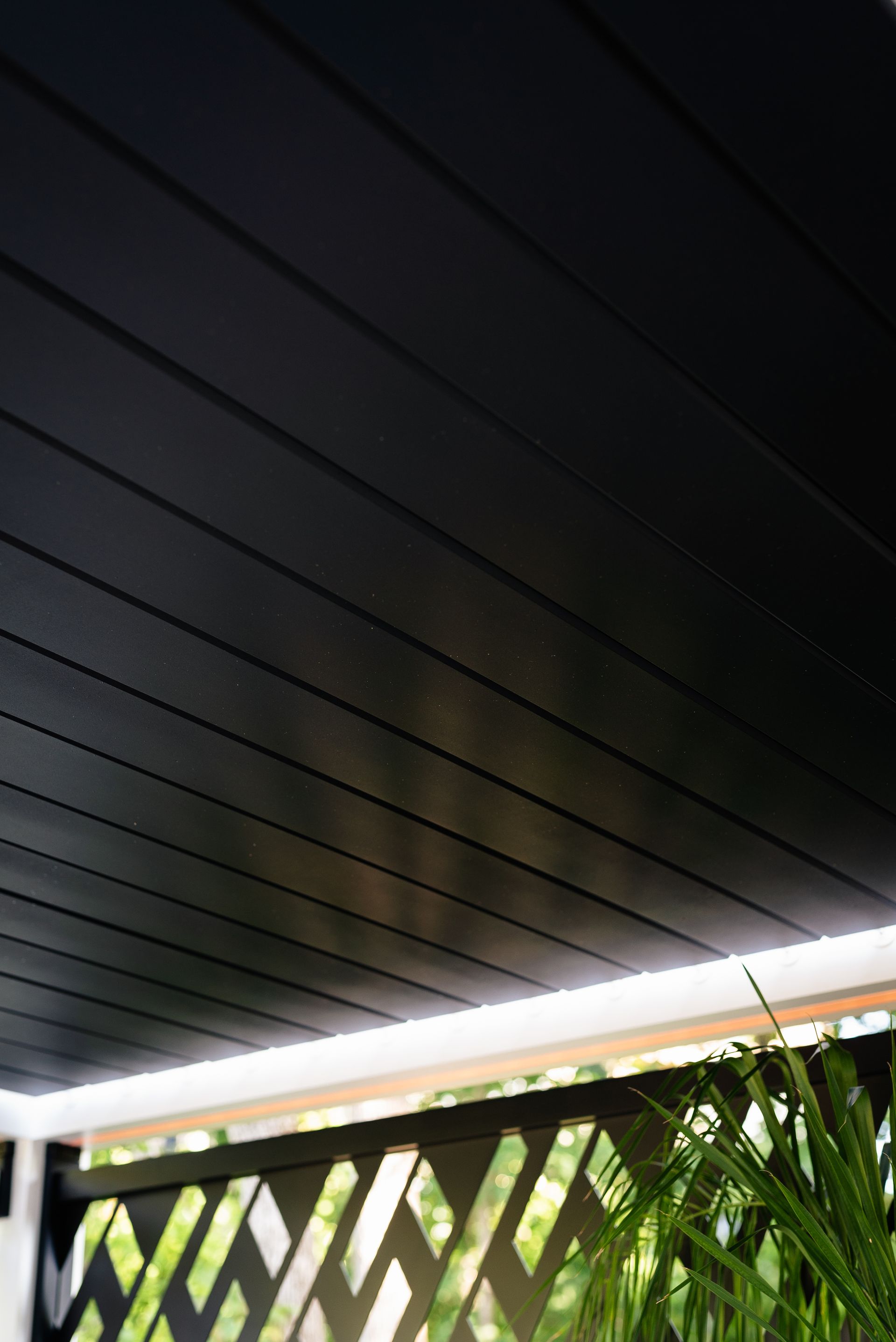 A black awning is hanging from the ceiling of a building.