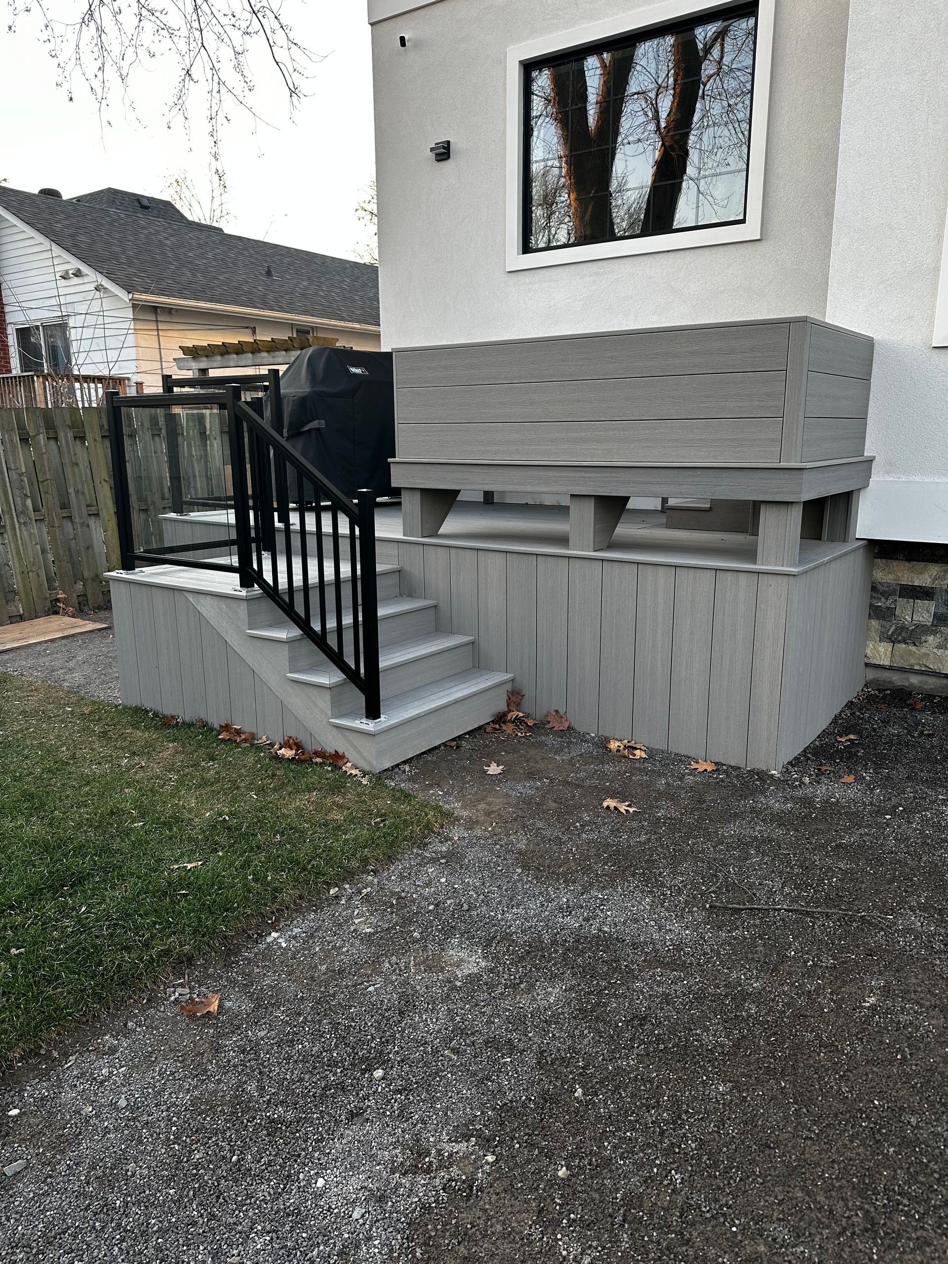A house with a deck and stairs on the side of it.