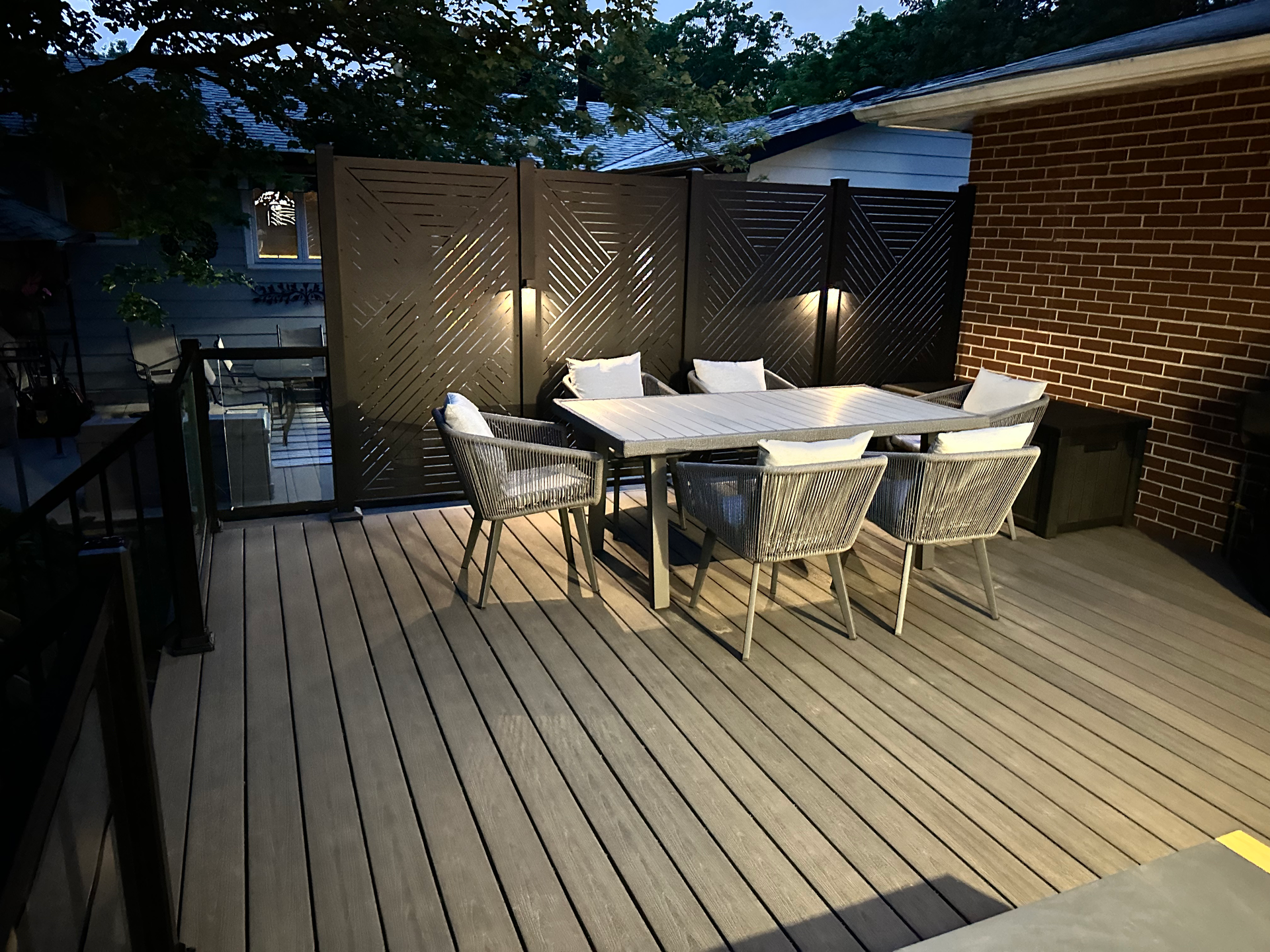 A wooden deck with a table and chairs on it