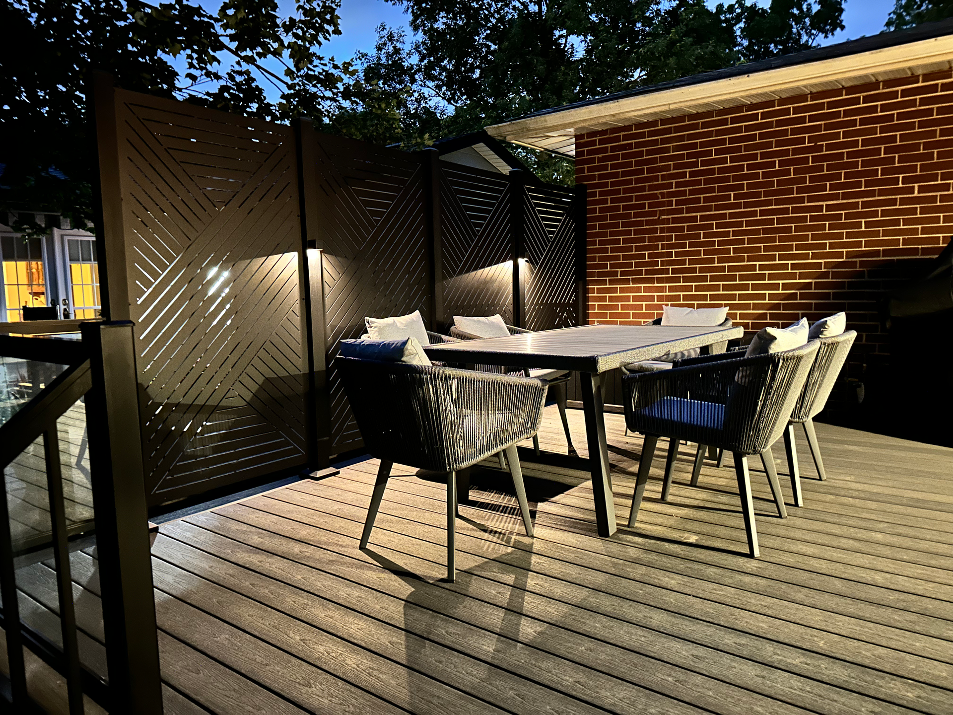 A wooden deck with a table and chairs on it.