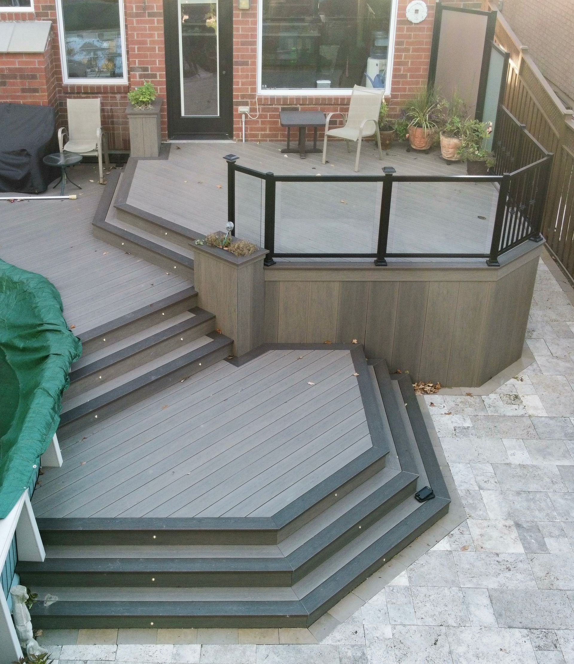 A wooden deck with lights on it is lit up at night.