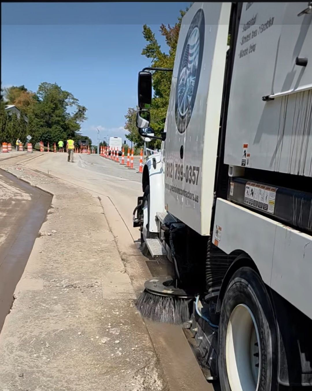 A truck sprays water on a road.