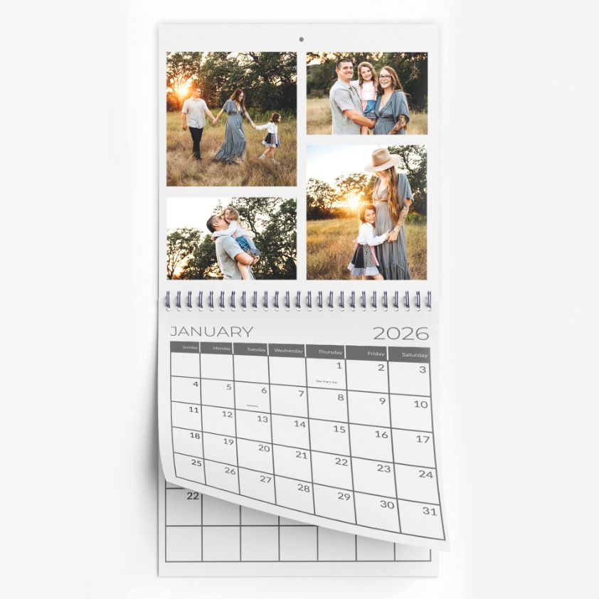 A calendar showing one photo of a family of three cuddling in tall grass.