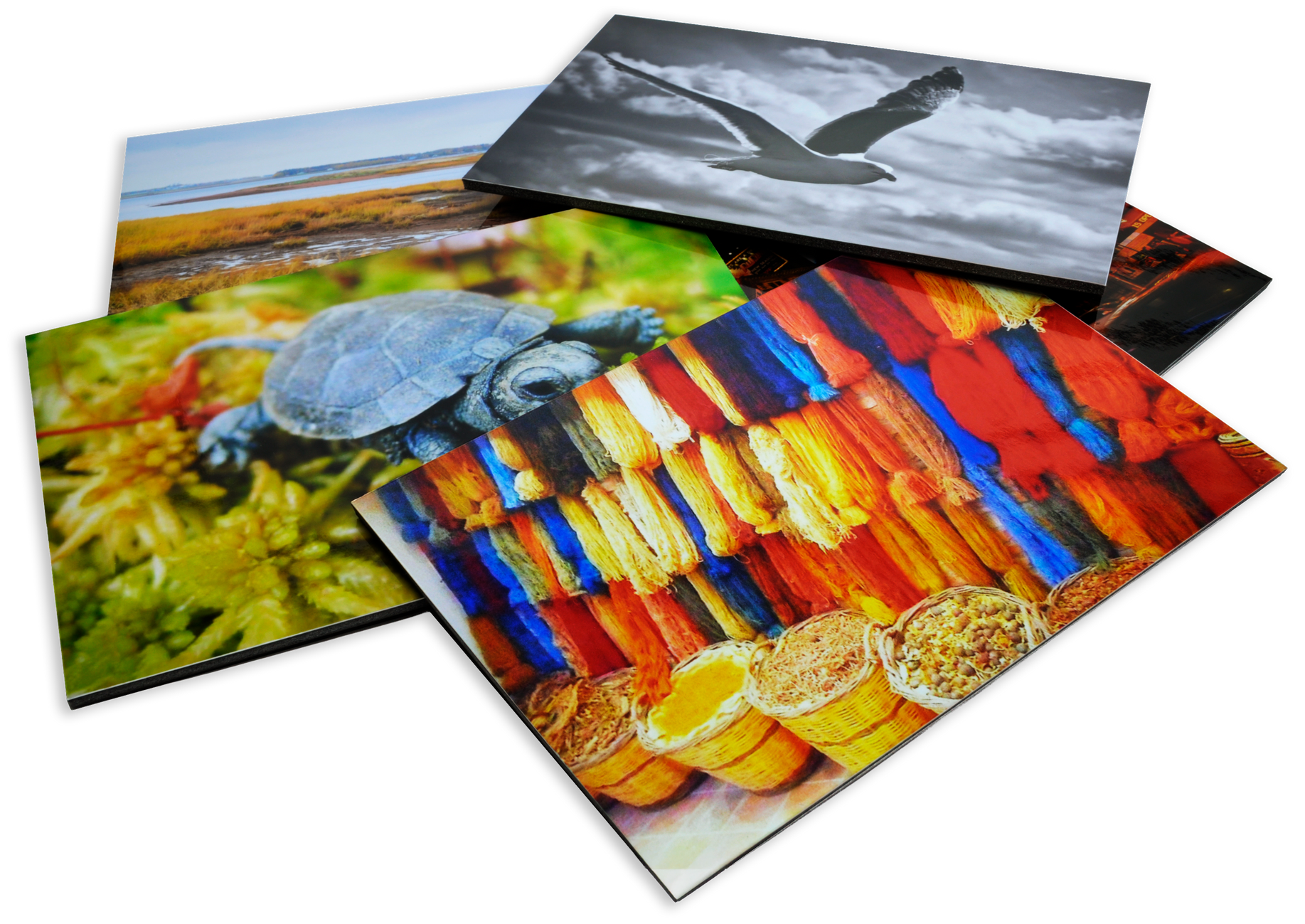 A pile of large prints that have been mounted and laminated.