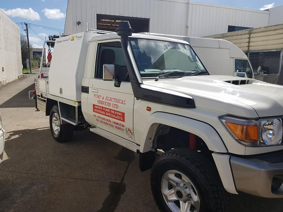 White utility truck in an industrial building White utility truck in an industrial building