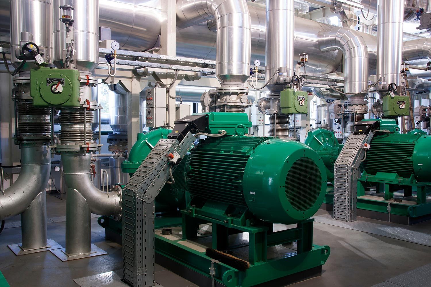 Green industrial pumps and silver pipes Green industrial pumps and silver pipes