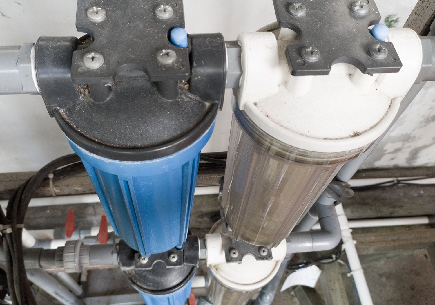 Water filters on metal pipes in a utility room Water filters on metal pipes in a utility room