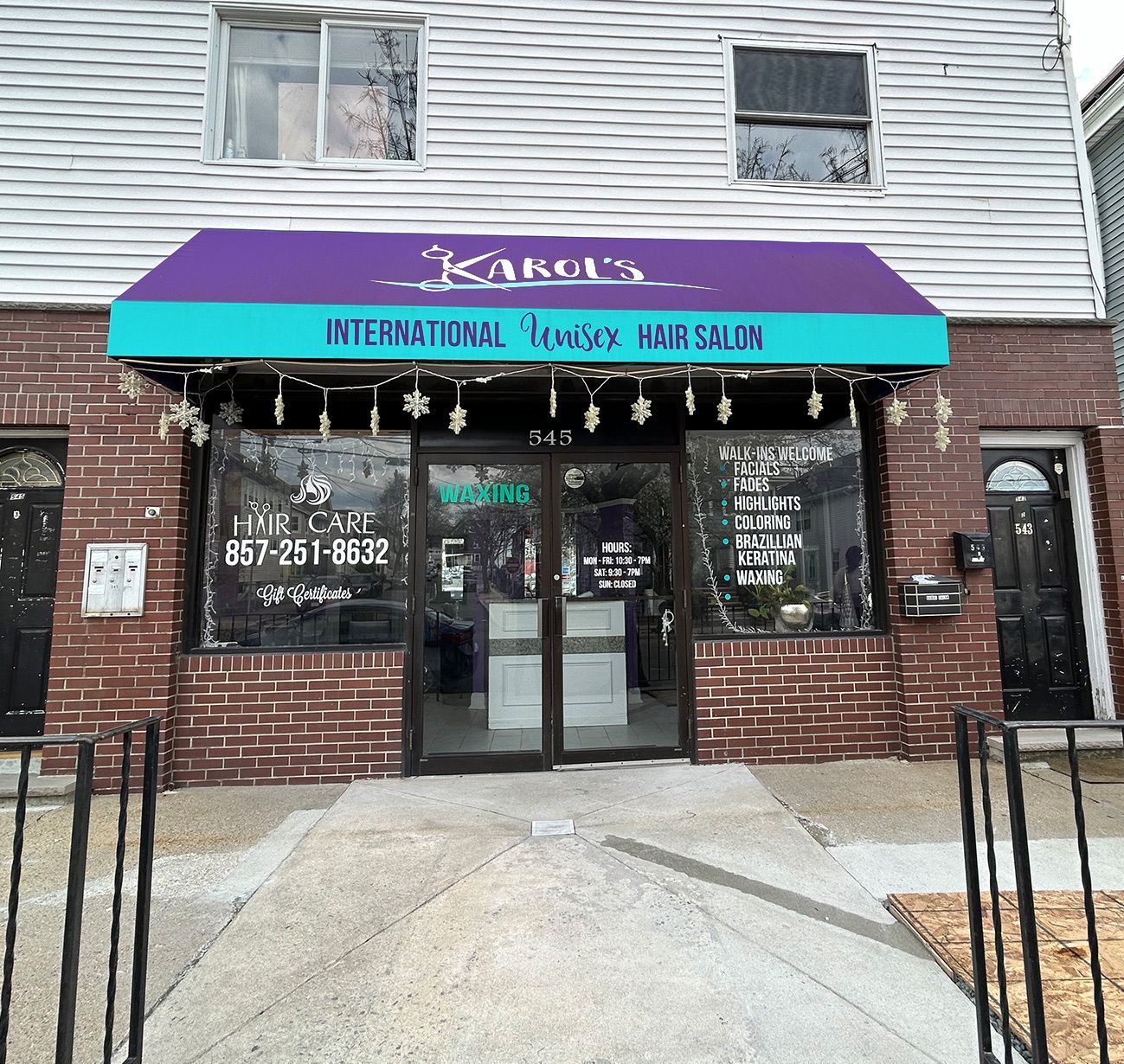 The front of a hair salon with a purple awning