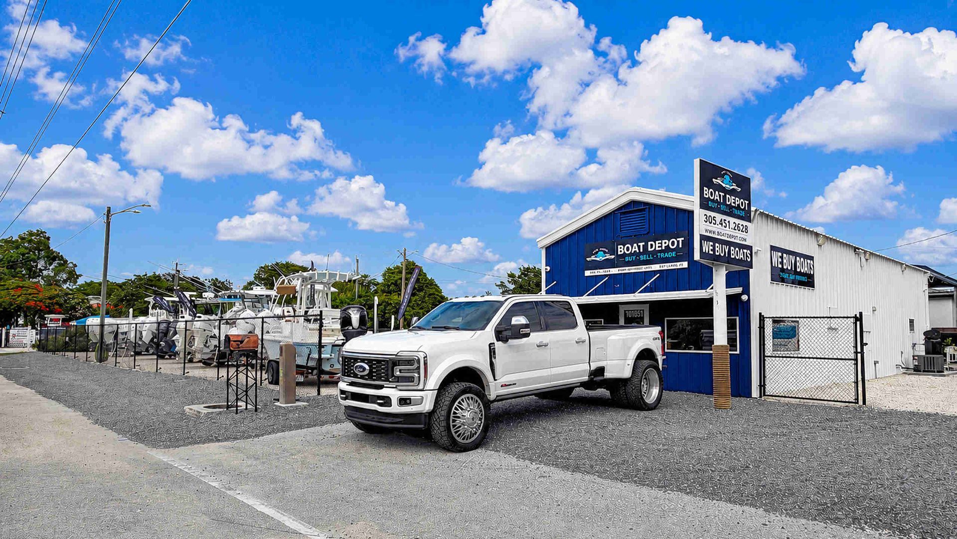 Main Boat Depot Dealership with new white tow truck and sales office in background