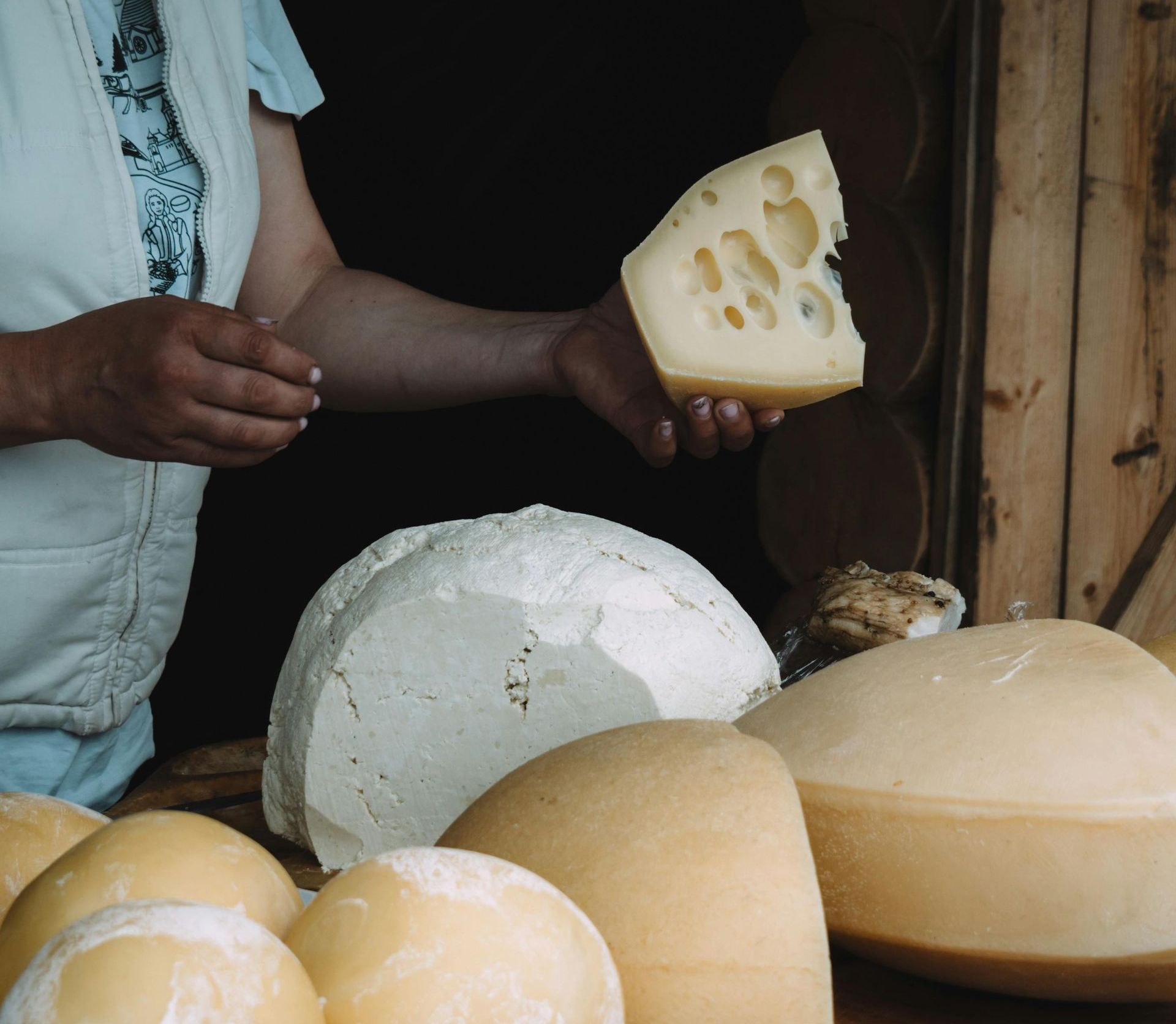 Cheesemaker presents different types of cheese