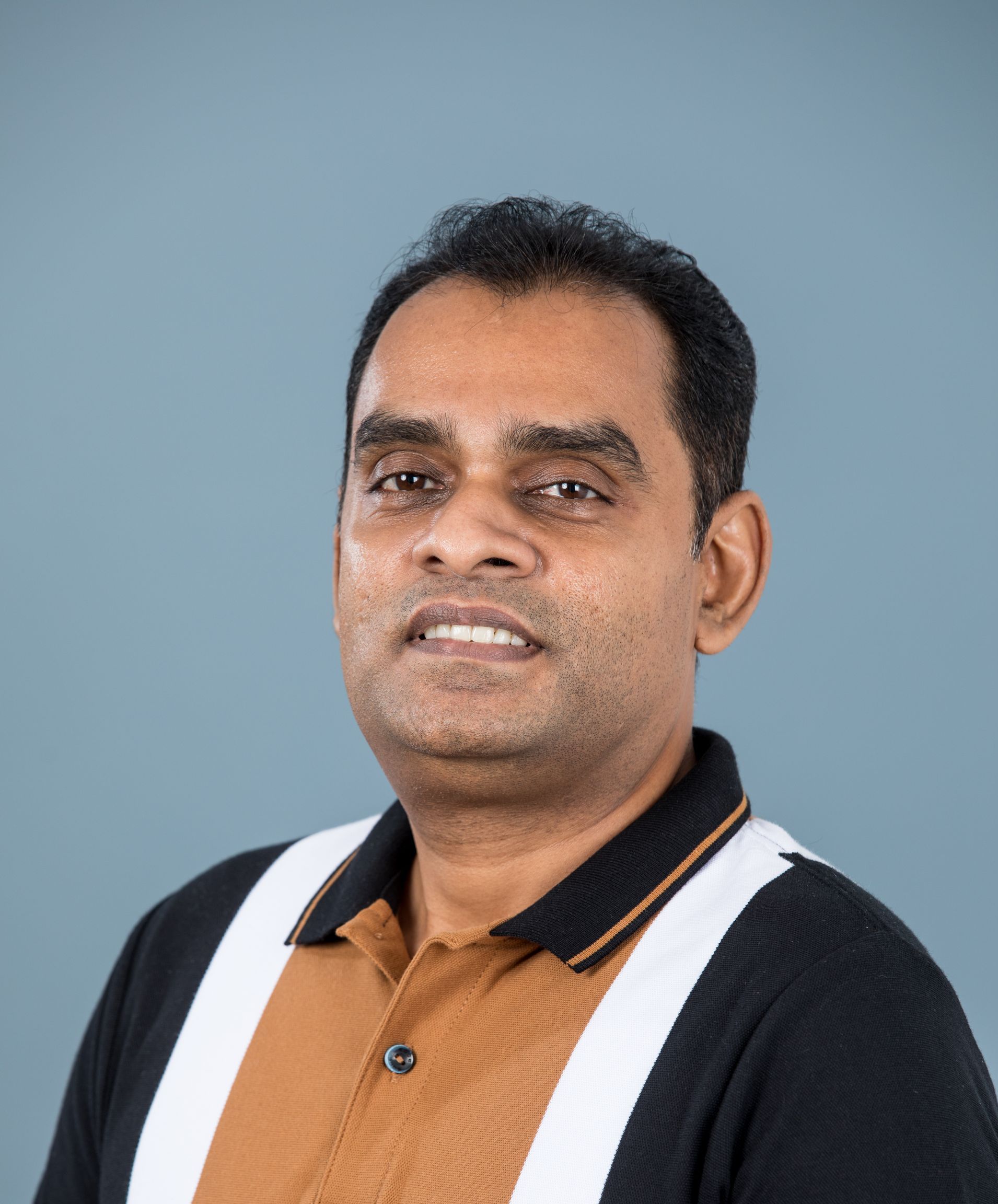 A photo of Sugeeth smiling for the camera.